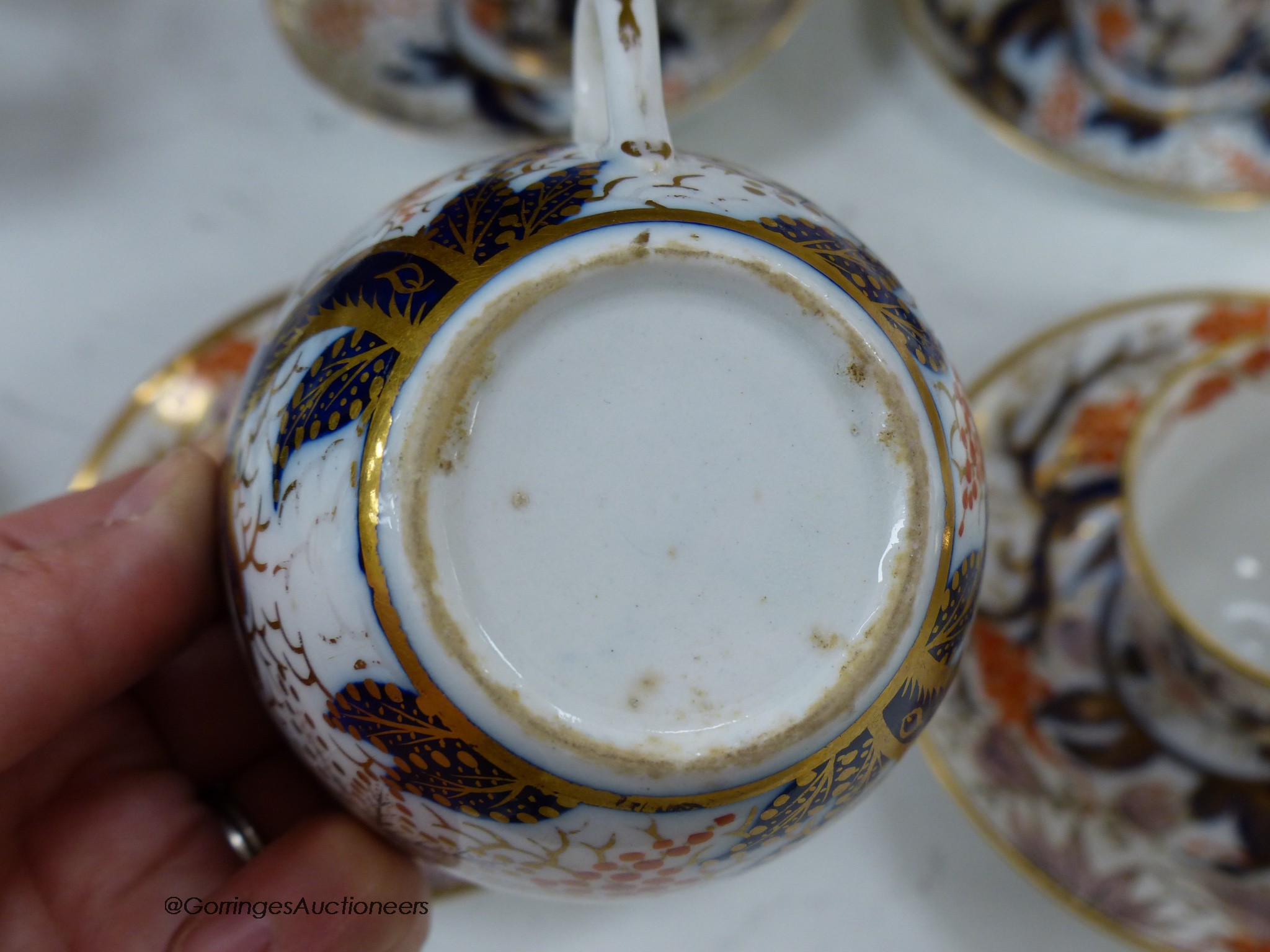 A New Hall part tea and coffee service painted with pattern 446, some pieces marked, consisting of a teapot cover and stand, sucrier and cover, two trios, six coffee cups and five saucers, teapot 16cm high including cove